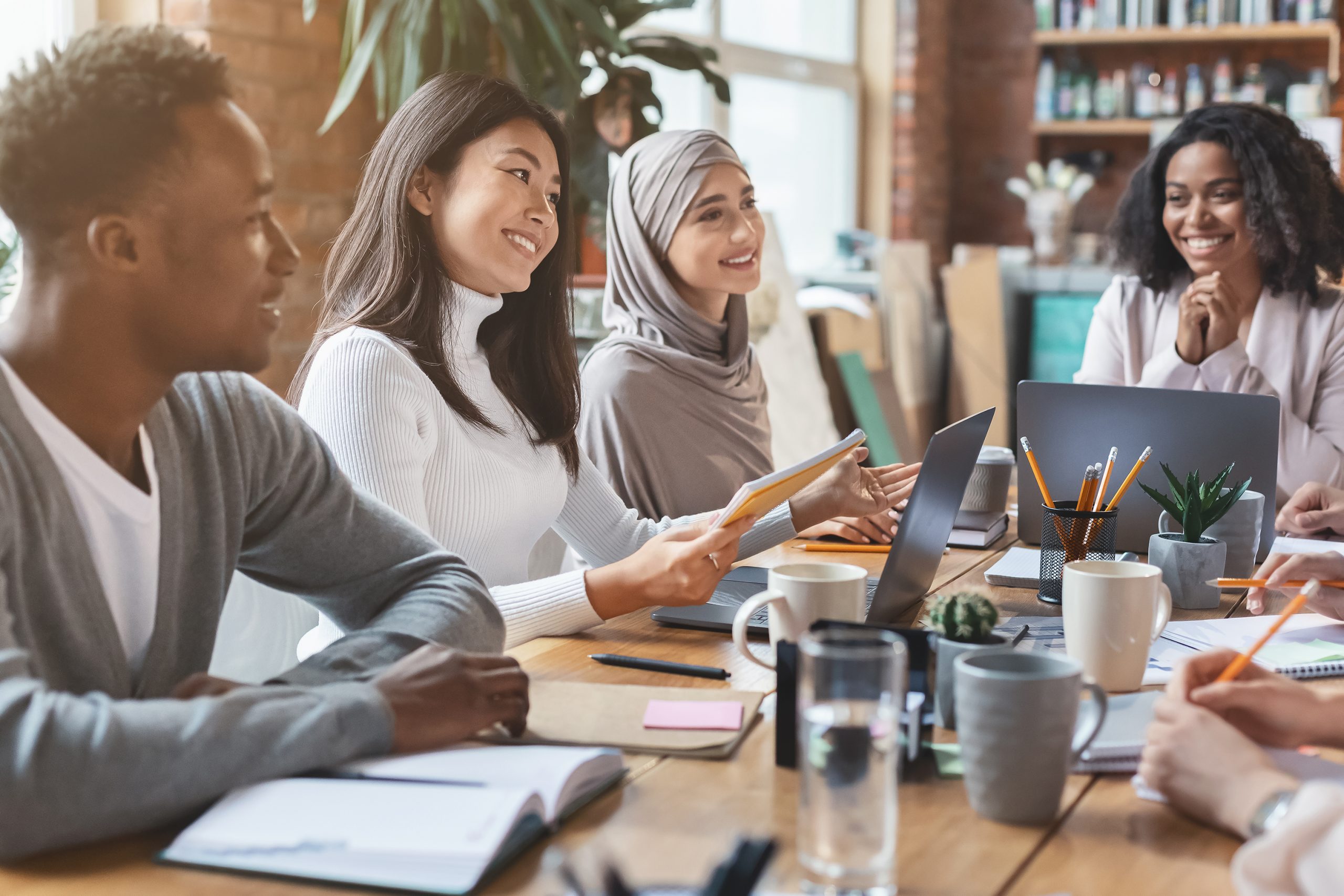 Employees meeting around table